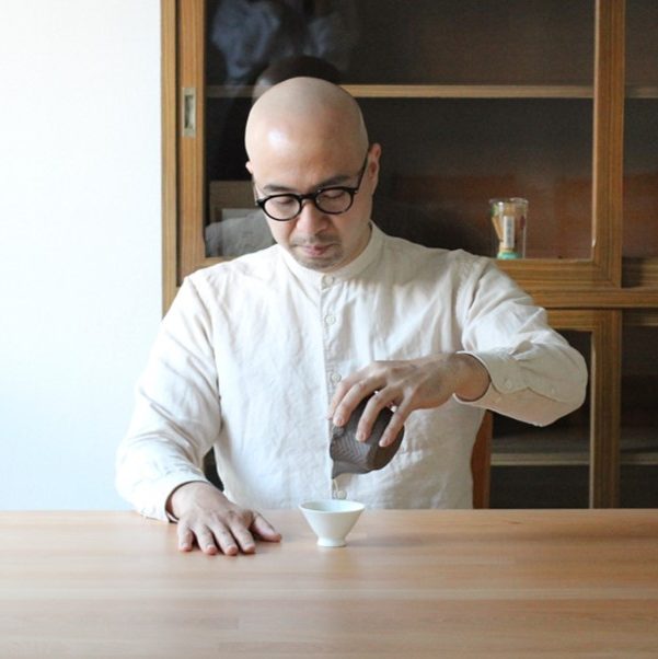 Host making tea